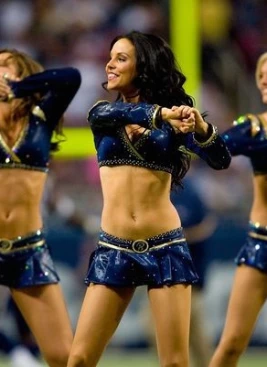 St. Louis Rams cheerleaders sign their swimsuit calendar for a fan