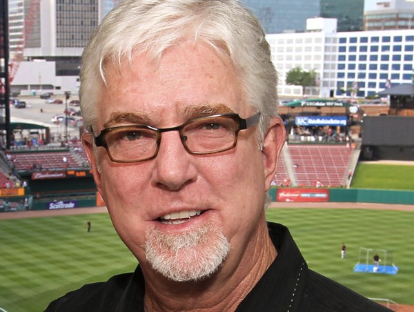 Giants announcer Mike Krukow leans on his service dog, Patriot, for support