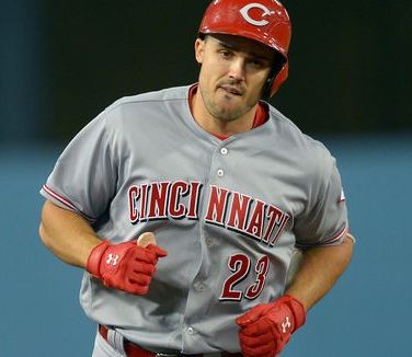 Adam Duvall of the Cincinnati Reds smiles in the dugout after hitting